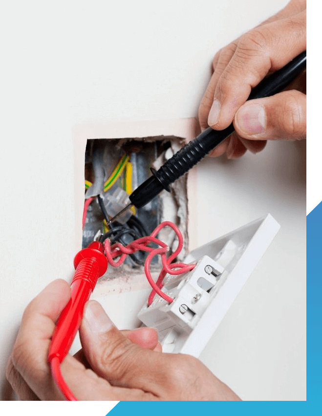 Electrician testing voltage in a light switch